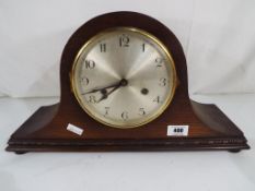An oak cased Napoleon's hat mantel clock with Arabic numerals,