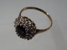 A lady's 9 carat yellow gold cluster ring set with sapphires, size P, approx 2.