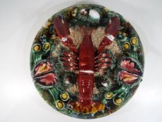 A large Palissy type plaque depicting a sea-bed scene featuring a lobster,