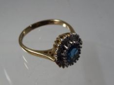 A lady's 9 carat yellow gold cluster ring set with a central stone probably of blue zircon