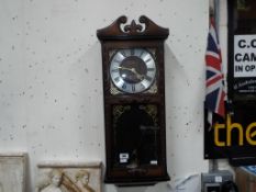 A President 30 day wall clock with pendulum and key.