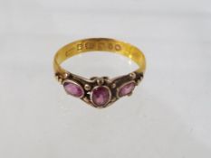 A lady's 22 carat gold ring set with three amethysts, approx 2.