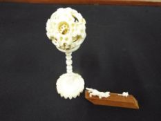 An early 20th Century highly carved worked ivory puzzle ball and further two pieces of worked ivory