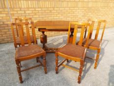 An oak draw leaf table c. 1920's and 4 matching dining chairs. 76 cm x 110 cm x 76 cm.
