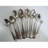 A small quantity of hallmarked silver spoons and a pickle fork with various assays,