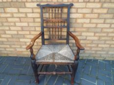A Victorian rush seated armchair