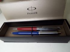 A Conway Stewart propelling pencil and a Sheaffer propelling pencil within a Parker box