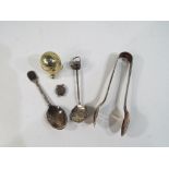 A small collection of silver and other white metal items comprising a sterling silver leaf spoon