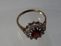 A lady's 9 carat yellow gold cluster ring set with garnet and cz, size O + 1/2, approx 2.