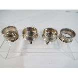A pair of European silver salts stamped 800 on scroll feet, a hallmarked silver napkin ring,