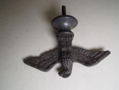 A white metal figure depicting an Eagle with Spread Wings on a base with screw thread below,