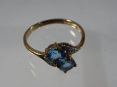 A lady's 9 carat yellow gold two stone cross-over ring, size O + 1/2, approx 1.