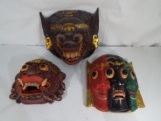 Tribal Wall Art - three highly carved hand painted treen masks.