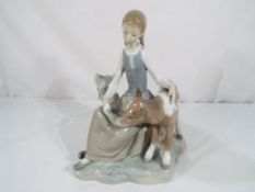 Lladro - A Lladro figurine entitled "Girl with Calf" # 01004813,
