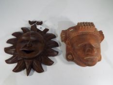 Wall Masks - a hand-made plaster tribal wall mask and a carved wooden mask (2).