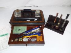 A wooden inlaid desk set with single drawer containing Lancashire Constabulary badge,