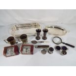 A good lot to include a quantity of silver plated and white metal items comprising a pair of small