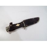 A Hitler youth style small camp knife in leather sheath, 12 cm blade, overall length 22 cm.