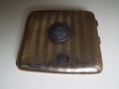 A white metal cigarette case with engine turned decoration to the front and bearing an applied