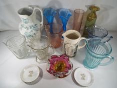 A quantity of various coloured glass vas