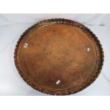 A large planished copper tray with engra