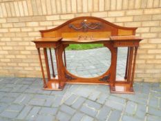 An oak highly carved over mantel mirror,