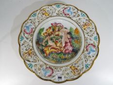 A large scallop edged ceramic Capodimonte charger decorated with a classical scene,