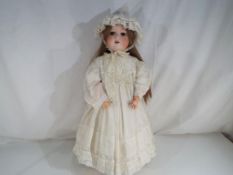 Armand Marseile - a good quality bisque headed doll with sleeping glass eyes,