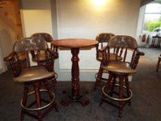 A mahogany bar table with four swivel bar stools with green faux leather seats and button back,
