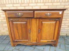 An oak cupboard with two cupboard doors and two drawers, approximately 92 cm (h) x 121 cm x 50 cm.