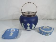 Wedgwood - A dark blue Wedgwood Jasperware biscuit barrel with plated handle and lid,