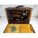 A vintage Singer sewing machine in carry case.