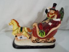 Thomas Pacconi Classics - a ceramic figurine depicting a couple in a horse drawn sleigh with