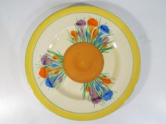 Clarice Cliff - a large plate by Clarice Cliff in the Crocus pattern, stamped to the base,