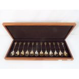 A cased set of twelve solid sterling silver commemorative spoons by John Pinches from the Royal