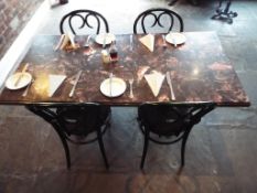 A faux marble topped table with cast iron supports,
