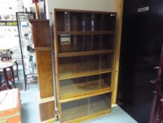 A glass fronted oak five section bookcase with sliding door approx 166cm x 91cm x 27cm