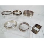 A small parcel of hallmarked silver comprising five bangles and a napkin ring, various assay marks,