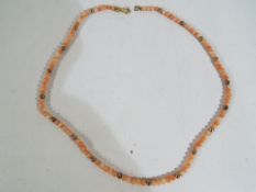 A lady's hallmarked 9 carat gold and coral bead necklace.
