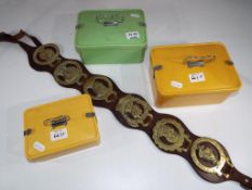 Three Bakelite boxes and a leather strap containing a selection of horse brasses - Est £20 - £30