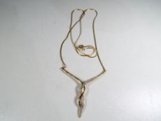 A 9 carat gold and diamond pendant and chain,