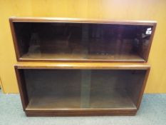 A glass fronted two section oak bookcase with sliding door approx 75cm x 91cm x 27cm