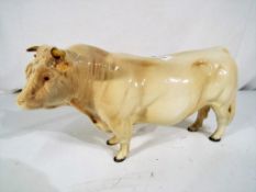 Beswick Pottery - A ceramic model of a Charolais bull by Beswick Pottery,
