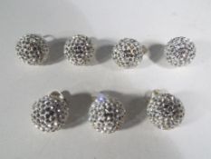 A collection of seven silver ball pendants