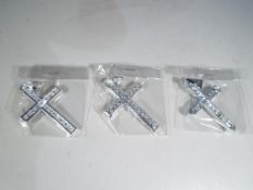 A collection of three brand new silver and cz cross pendants.