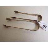 Two hallmarked silver tongs, one with maker's mark William Ely,