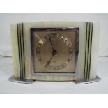 A white marble mantel clock with inlaid malachite by F.W.