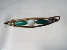 A 9ct gold hair slide set with opal and jade beaded detailing Est £20 - £40