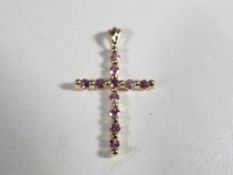 A 9 carat gold and pink sapphire cross