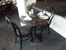 A faux marble round table approx 73cm (h) x 70cm (d) with two bentwood chairs